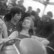zwei junge Frauen sitzen im Waggon einer Achterbahn der 1950er