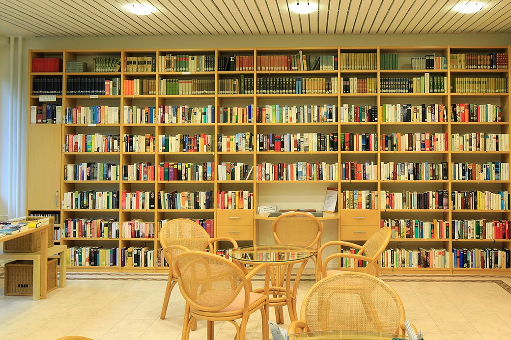 Bibliothek mit Stühlen und Bücherregal